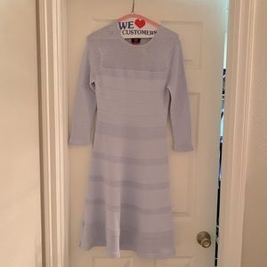 Very light blue, three quarter sleeve dress. Fitted in middle, A line